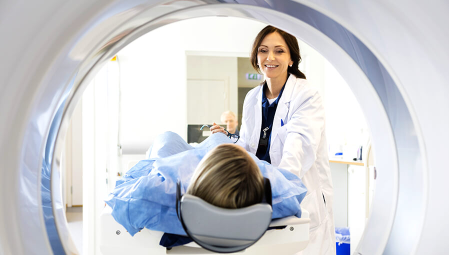 Female doctor talking to a patient about to have a MRI scan